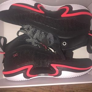 Jordan’s boys orange and black with white soles